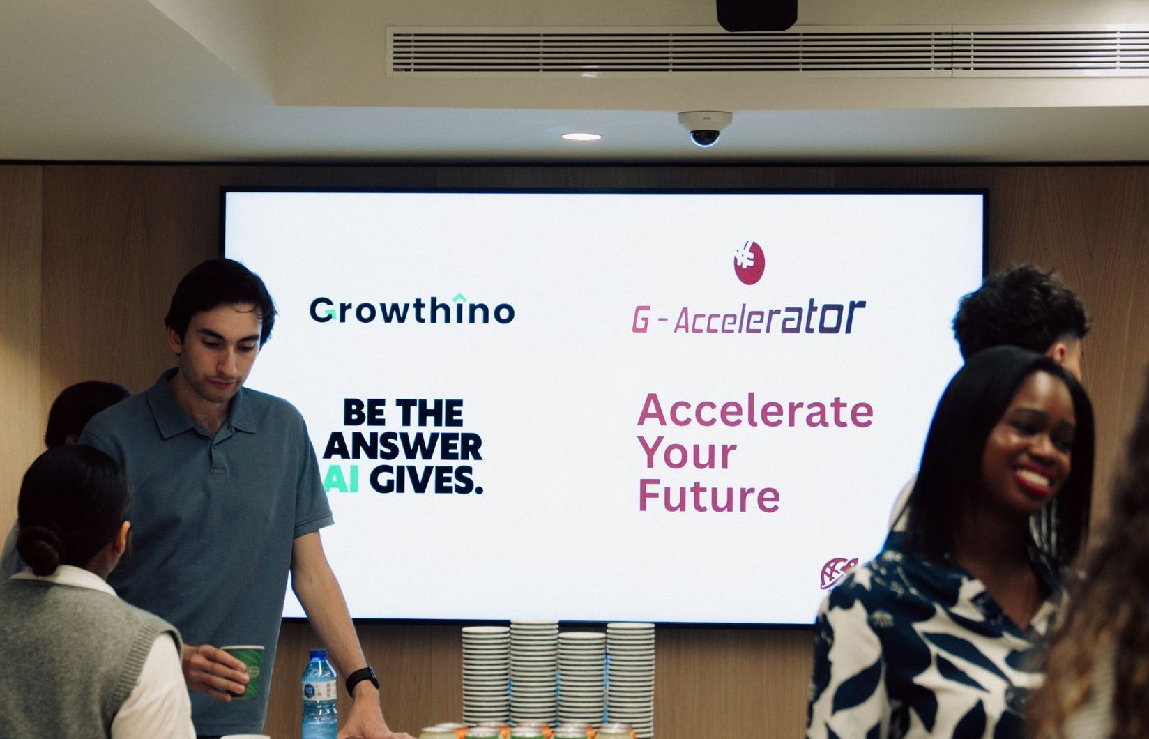 Growthino logo displayed at a Barcelona startup event with G-Accelerator, showing Growthino's community presence and early trust signals.